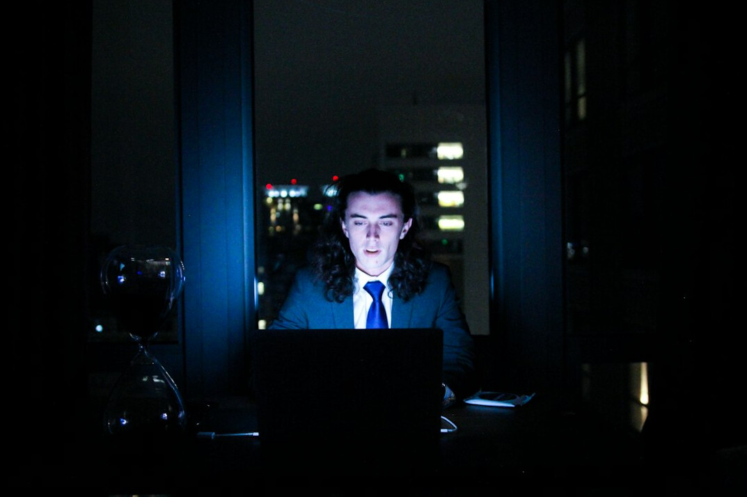 detective using laptop at night