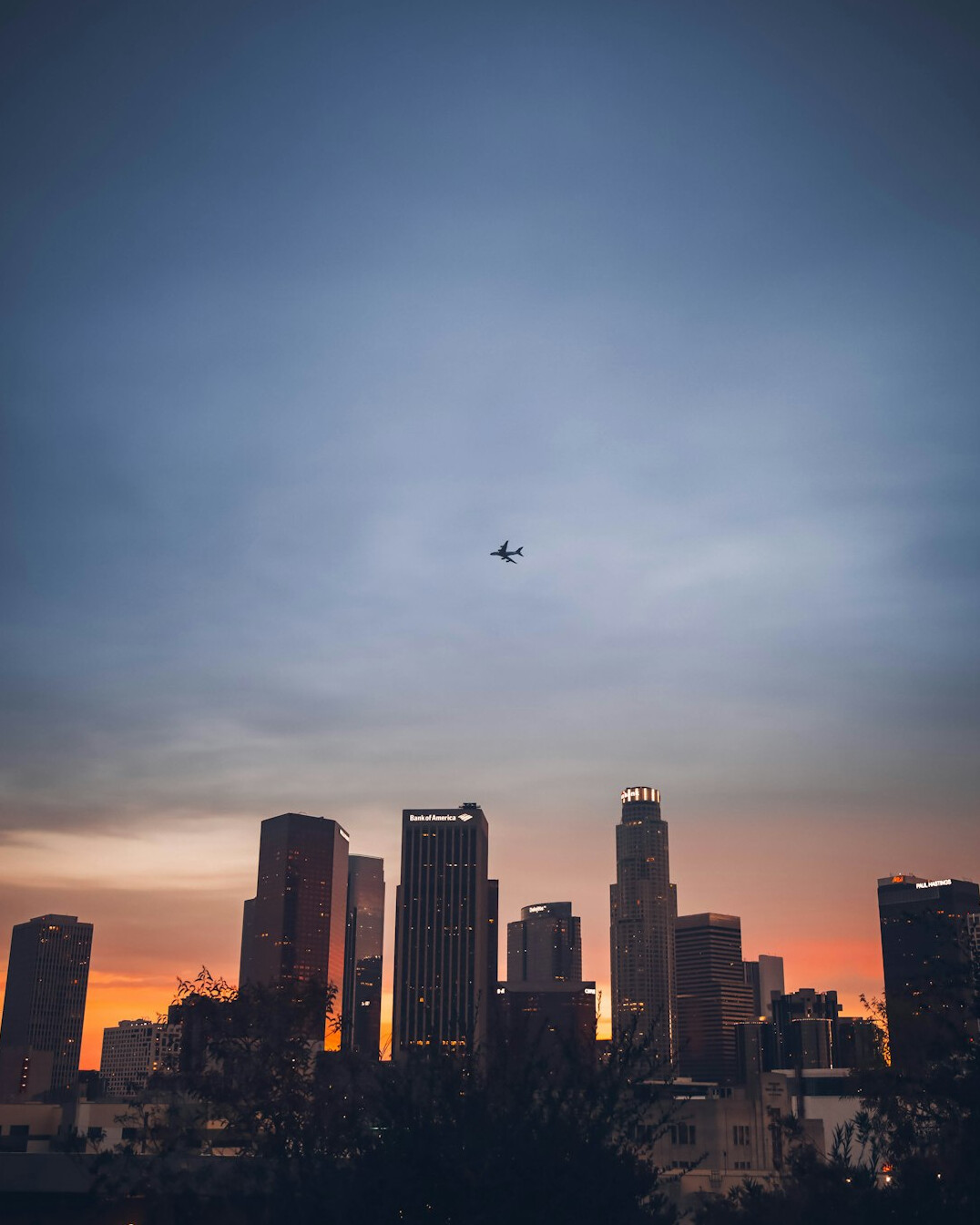 drone flying over city at dusk