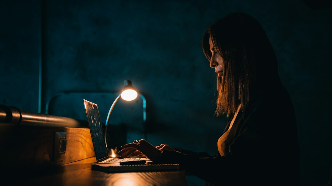 detective using laptop at night